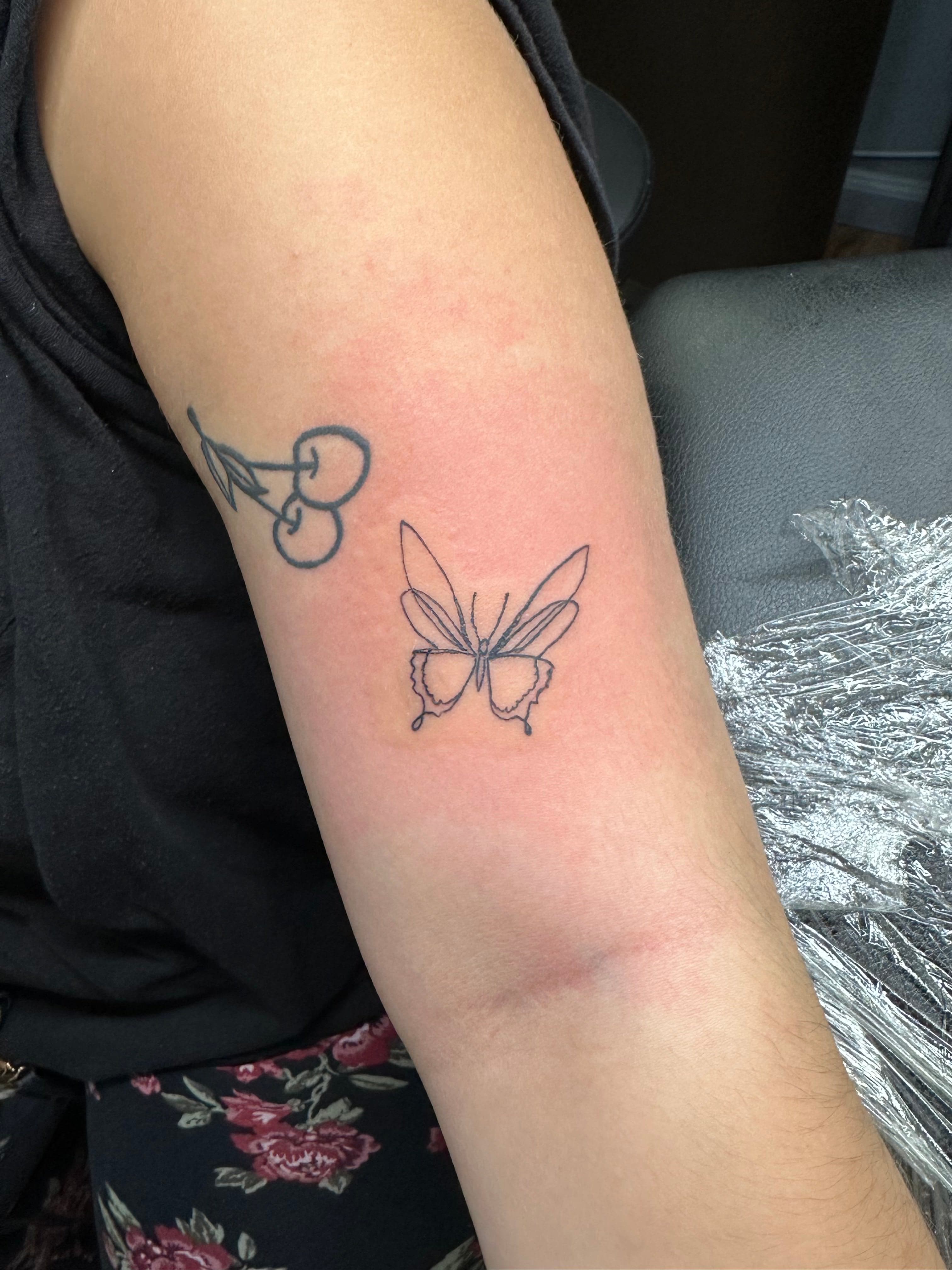 Fine line butterfly tattoo