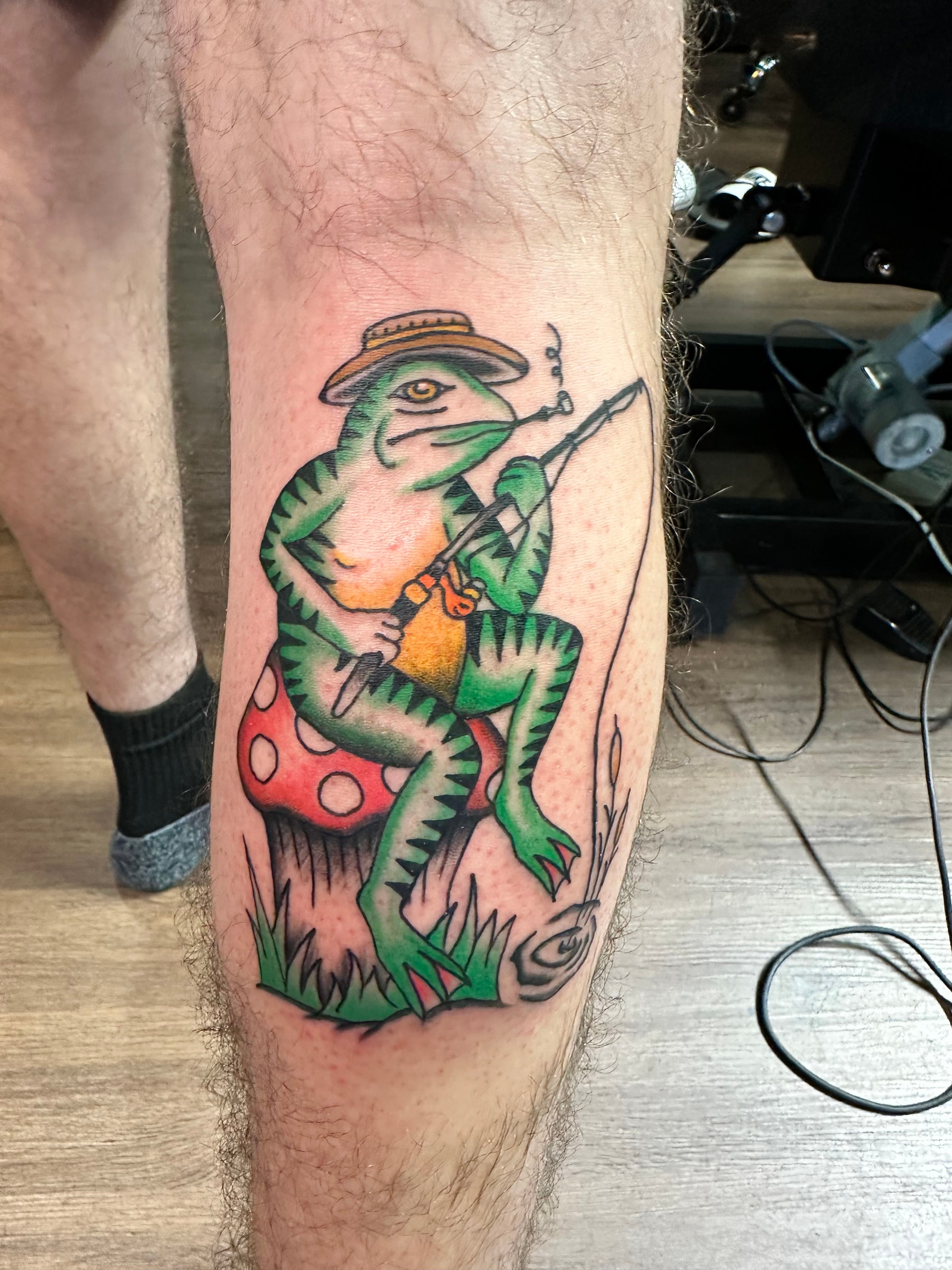 Country themed frog fishing tattoo