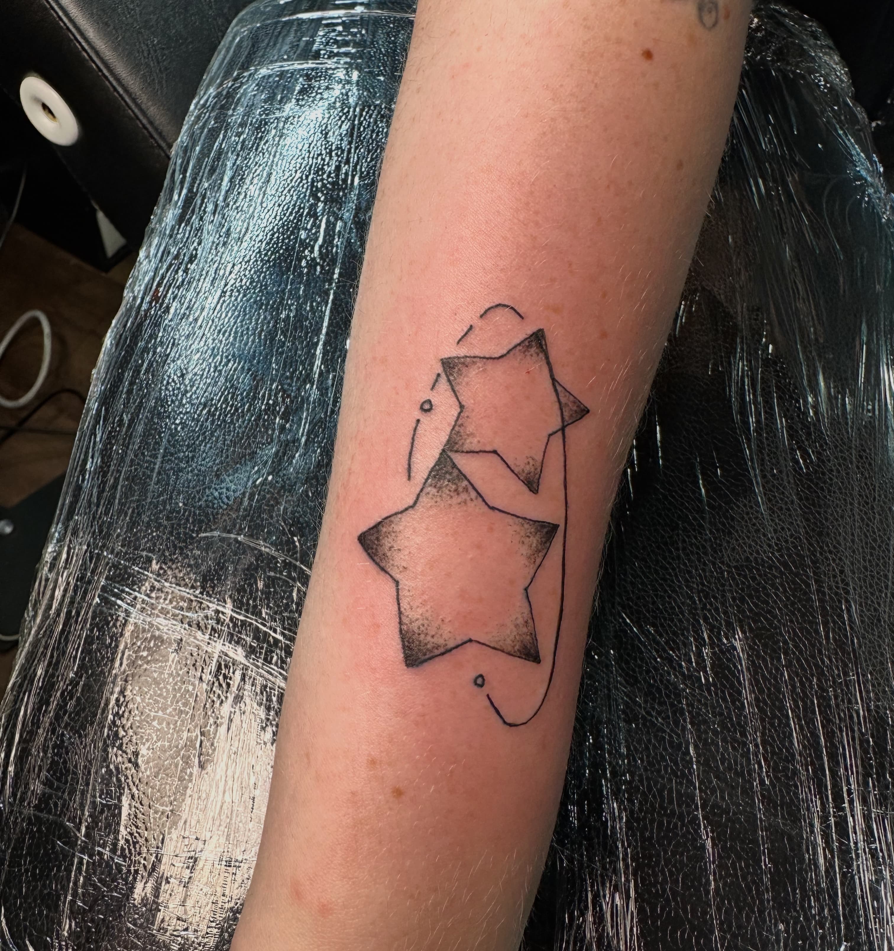 Two stars with ring around it